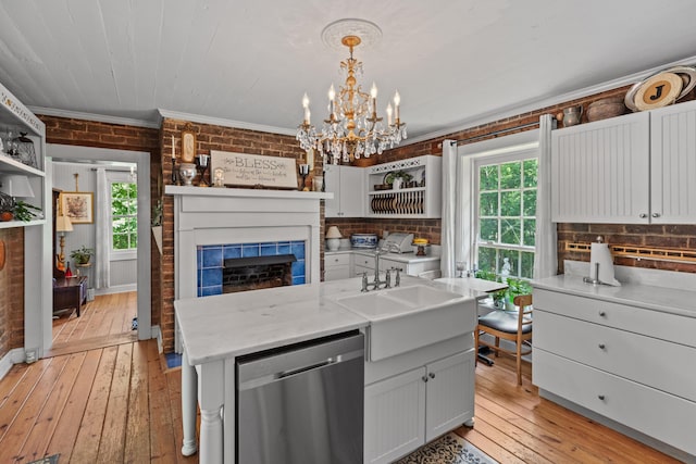 1130 Squirewood Way, Dandridge, TN 37725 - kitchen with stainless steel dishwasher, open shelves, ornamental molding, brick wall, and light wood-style flooring