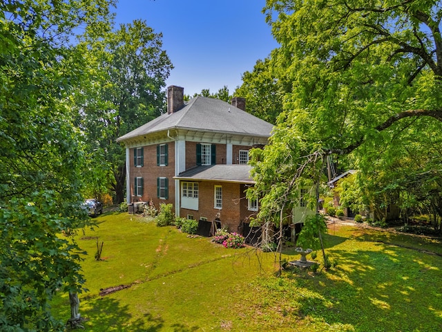 1130 Squirewood Way, Dandridge, TN 37725 - back of property with a chimney, brick siding, and a yard