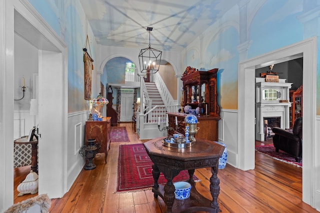 1130 Squirewood Way, Dandridge, TN 37725 - entryway with wood-type flooring, a wainscoted wall, a decorative wall, stairs, and a fireplace