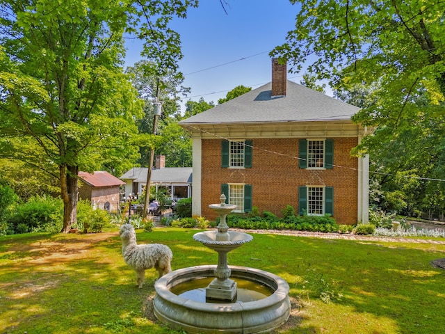 1130 Squirewood Way, Dandridge, TN 37725 - view of front of house with a chimney, a front lawn, brick siding, and roof with shingles
