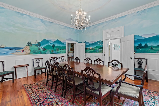 1130 Squirewood Way, Dandridge, TN 37725 - dining area featuring a decorative wall, a wainscoted wall, a chandelier, and wood finished floors