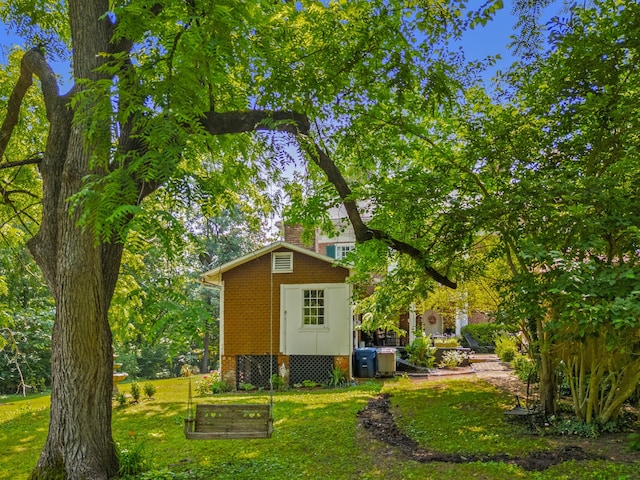 1130 Squirewood Way, Dandridge, TN 37725 - view of property exterior featuring a yard, a vegetable garden, an outdoor structure, and a chimney