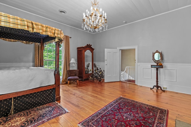 1130 Squirewood Way, Dandridge, TN 37725 - bedroom with a wainscoted wall, a chandelier, hardwood / wood-style floors, and ornamental molding