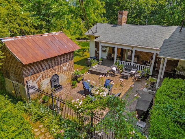 1130 Squirewood Way, Dandridge, TN 37725 - back of property with a patio, brick siding, a chimney, and outdoor lounge area