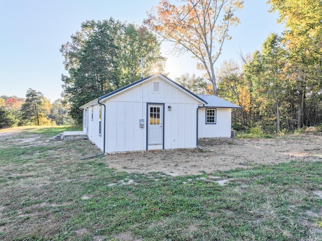 view of outbuilding featuring a lawn