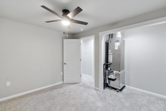 carpeted spare room with ceiling fan and heating unit