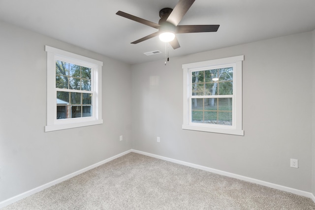 carpeted spare room with ceiling fan