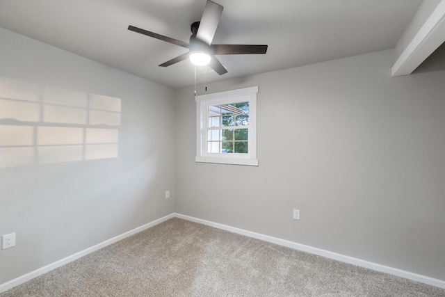 spare room featuring ceiling fan and carpet