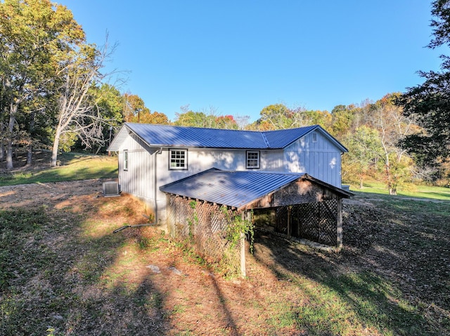 exterior space with a yard and central AC unit