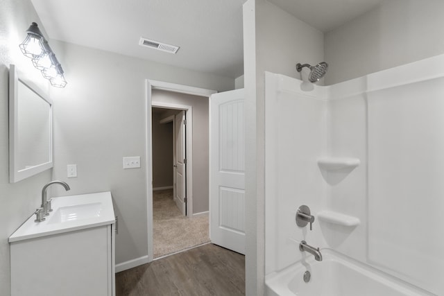 bathroom featuring vanity,  shower combination, and hardwood / wood-style flooring