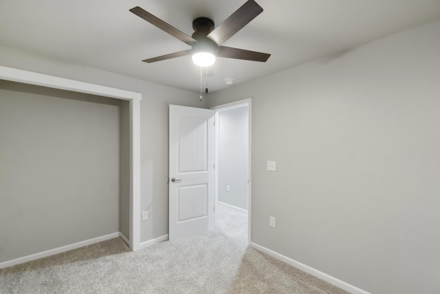 unfurnished bedroom featuring light colored carpet and ceiling fan