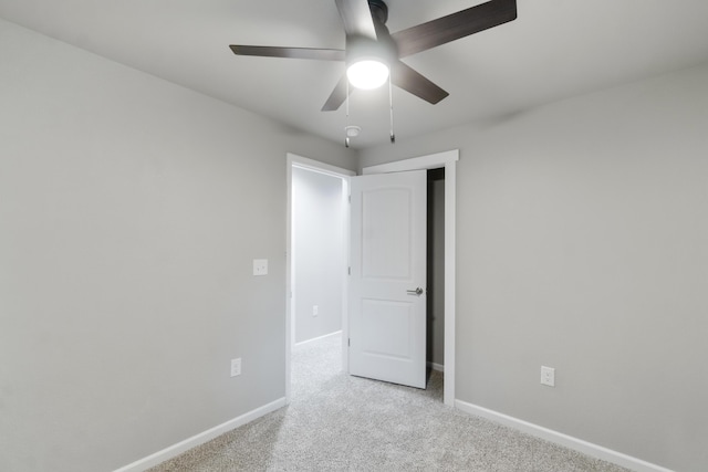 empty room with light carpet and ceiling fan