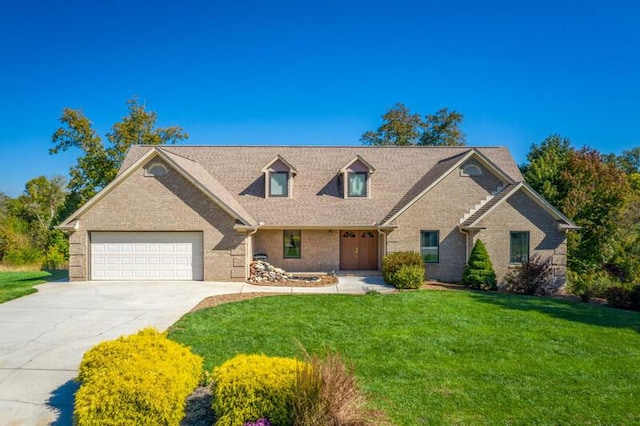 view of front of house featuring brick siding, an attached garage, driveway, and a front lawn