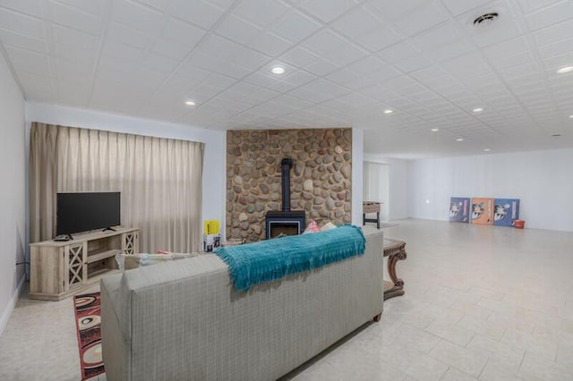 living area with recessed lighting, a wood stove, and visible vents