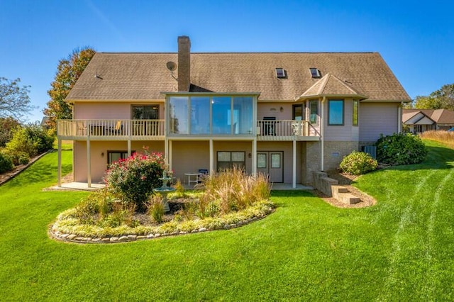 rear view of house with a patio area, a chimney, and a lawn