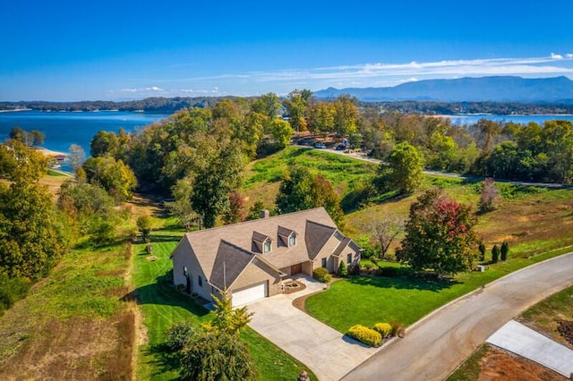 drone / aerial view featuring a water and mountain view