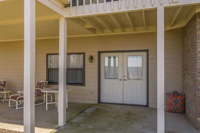 property entrance featuring french doors and a patio area