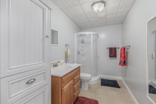 full bath featuring a stall shower, tile patterned flooring, vanity, and baseboards