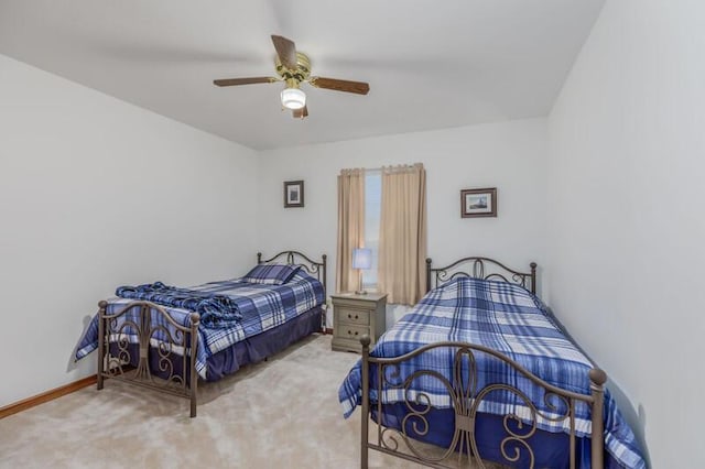 bedroom with ceiling fan, carpet floors, and baseboards