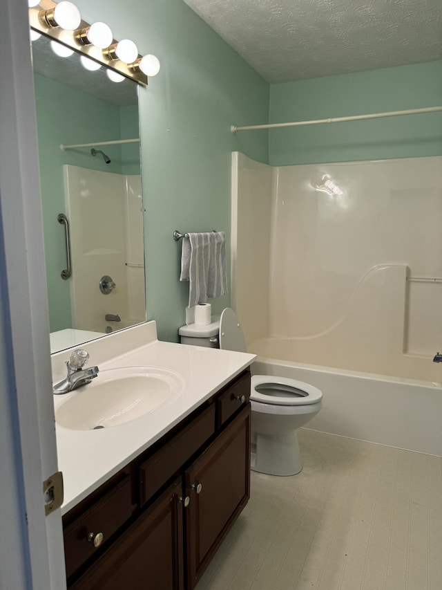 full bathroom with vanity, toilet, a textured ceiling, and washtub / shower combination