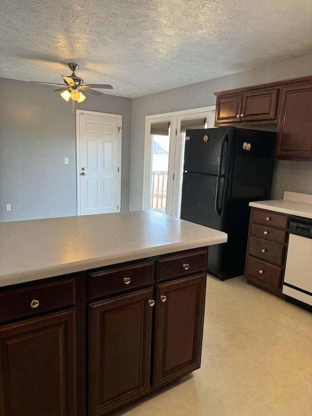 kitchen with black refrigerator, dishwasher, ceiling fan, dark brown cabinetry, and a textured ceiling