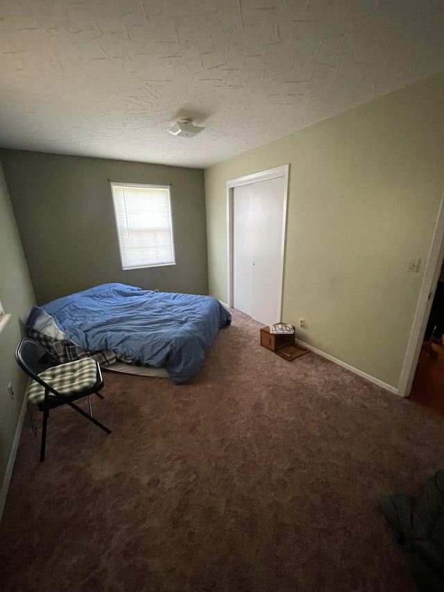 carpeted bedroom featuring baseboards