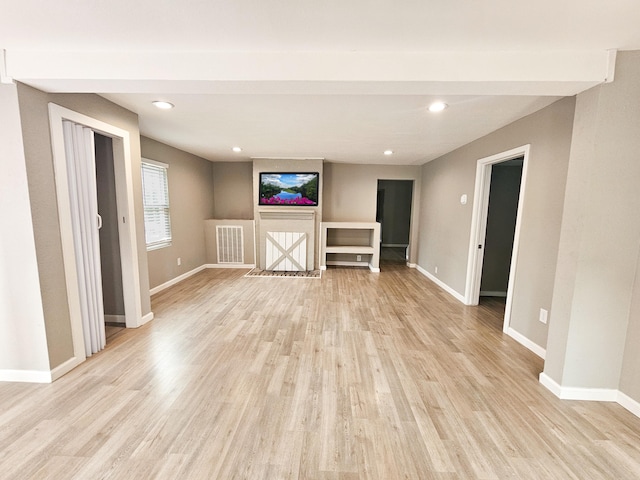 unfurnished living room with light hardwood / wood-style flooring