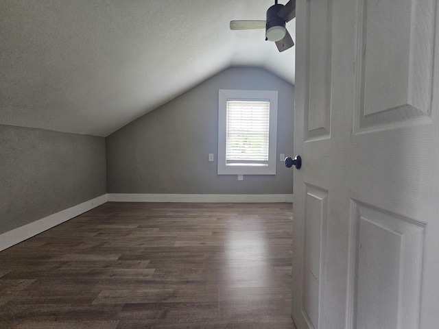 additional living space with ceiling fan, dark hardwood / wood-style flooring, and lofted ceiling