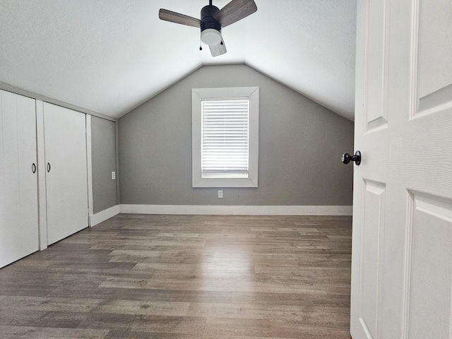 bonus room featuring hardwood / wood-style floors, ceiling fan, lofted ceiling, and a textured ceiling