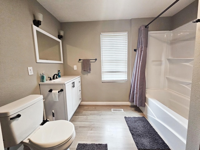 full bathroom with shower / bathtub combination with curtain, hardwood / wood-style flooring, vanity, and toilet