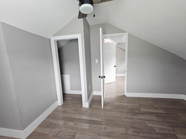 additional living space featuring wood-type flooring, ceiling fan, and lofted ceiling