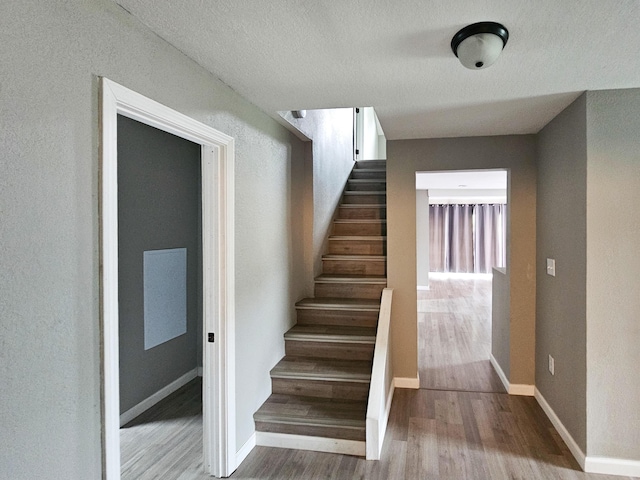 stairway featuring hardwood / wood-style flooring