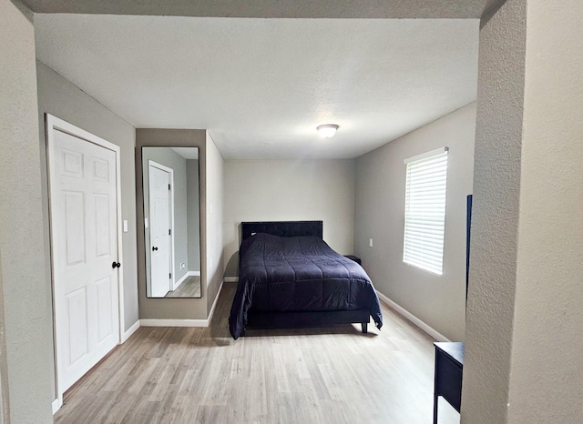 unfurnished bedroom featuring a textured ceiling and light wood-type flooring