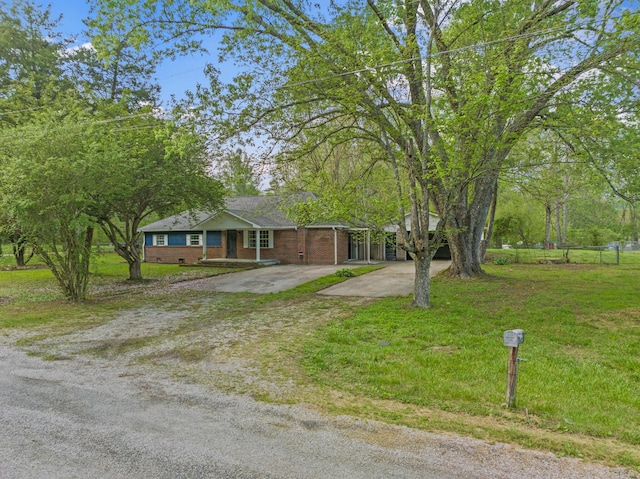 single story home with brick siding, a front lawn, fence, and driveway