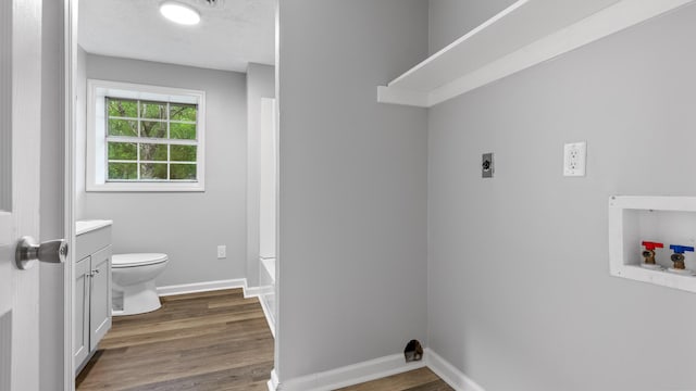 washroom featuring hookup for an electric dryer, laundry area, wood finished floors, baseboards, and hookup for a washing machine