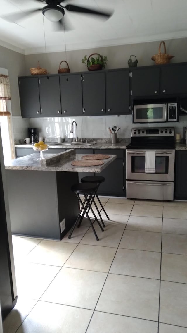 059/057.00 Spring Creek Rd, Dandridge, TN 37725 - kitchen with a sink, dark cabinetry, light tile patterned flooring, and stainless steel appliances