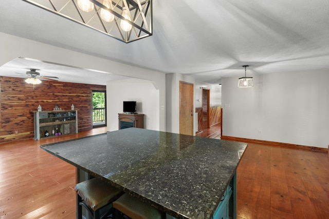 148 Delph Ln, Mooresburg, TN 37811 - kitchen with light wood-style floors, open floor plan, a ceiling fan, a fireplace, and wooden walls