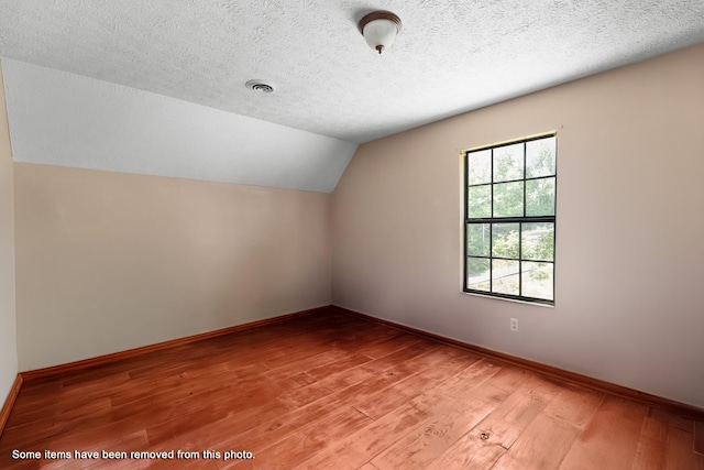 148 Delph Ln, Mooresburg, TN 37811 - bonus room with lofted ceiling, light wood finished floors, a textured ceiling, and baseboards