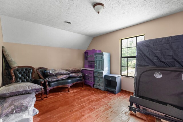 148 Delph Ln, Mooresburg, TN 37811 - bedroom with light wood finished floors, vaulted ceiling, and a textured ceiling