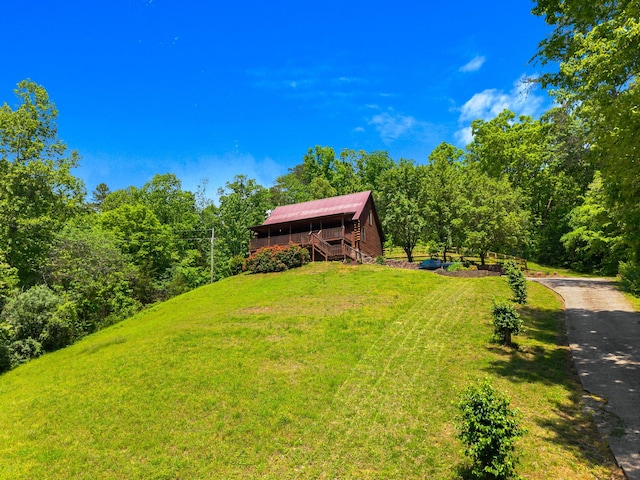 148 Delph Ln, Mooresburg, TN 37811 - view of green lawn featuring a deck, stairway, and a view of trees