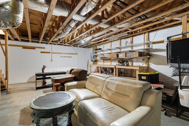148 Delph Ln, Mooresburg, TN 37811 - living area featuring unfinished concrete floors, a workshop area, and concrete block wall