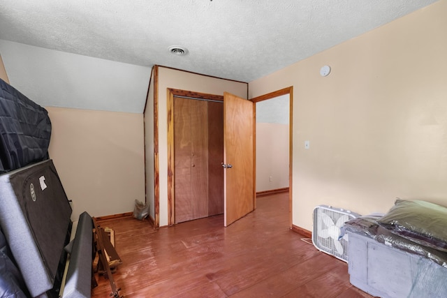 148 Delph Ln, Mooresburg, TN 37811 - bedroom with wood finished floors, a closet, a textured ceiling, baseboards, and lofted ceiling