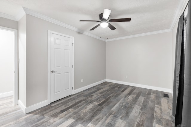 unfurnished bedroom featuring dark wood-type flooring, ceiling fan, ornamental molding, and a textured ceiling