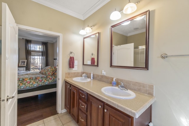 bathroom with tile patterned floors, vanity, and ornamental molding