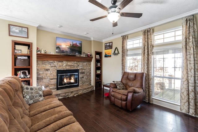 living room with a textured ceiling, plenty of natural light, dark hardwood / wood-style floors, and a fireplace