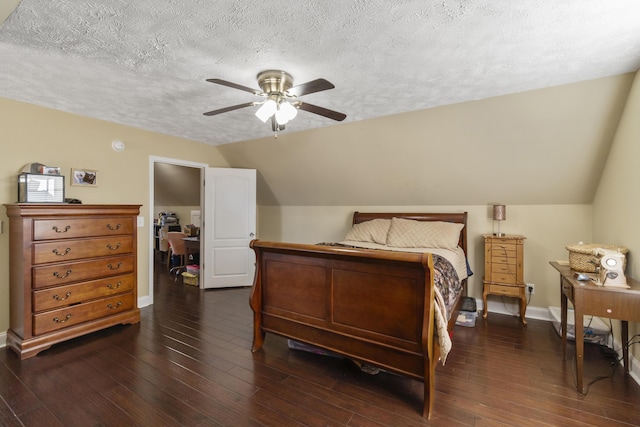 bedroom with vaulted ceiling, ceiling fan, dark hardwood / wood-style flooring, and a textured ceiling