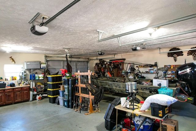 garage with a workshop area and a garage door opener