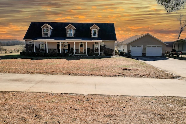 cape cod home with a carport, a porch, and a garage