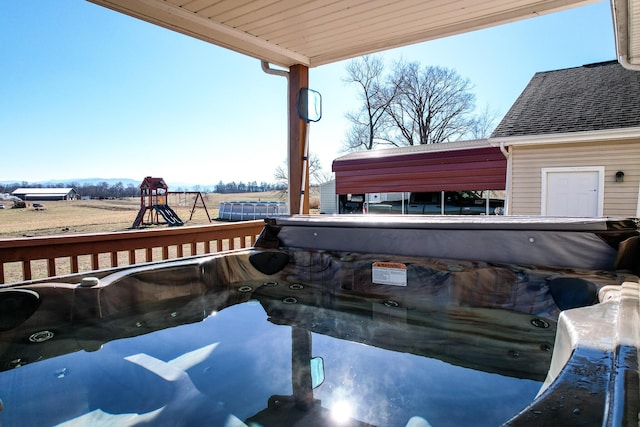 exterior space with a playground and a hot tub