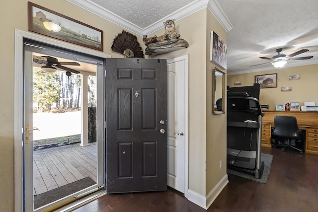 entryway featuring a textured ceiling, dark hardwood / wood-style floors, and ornamental molding